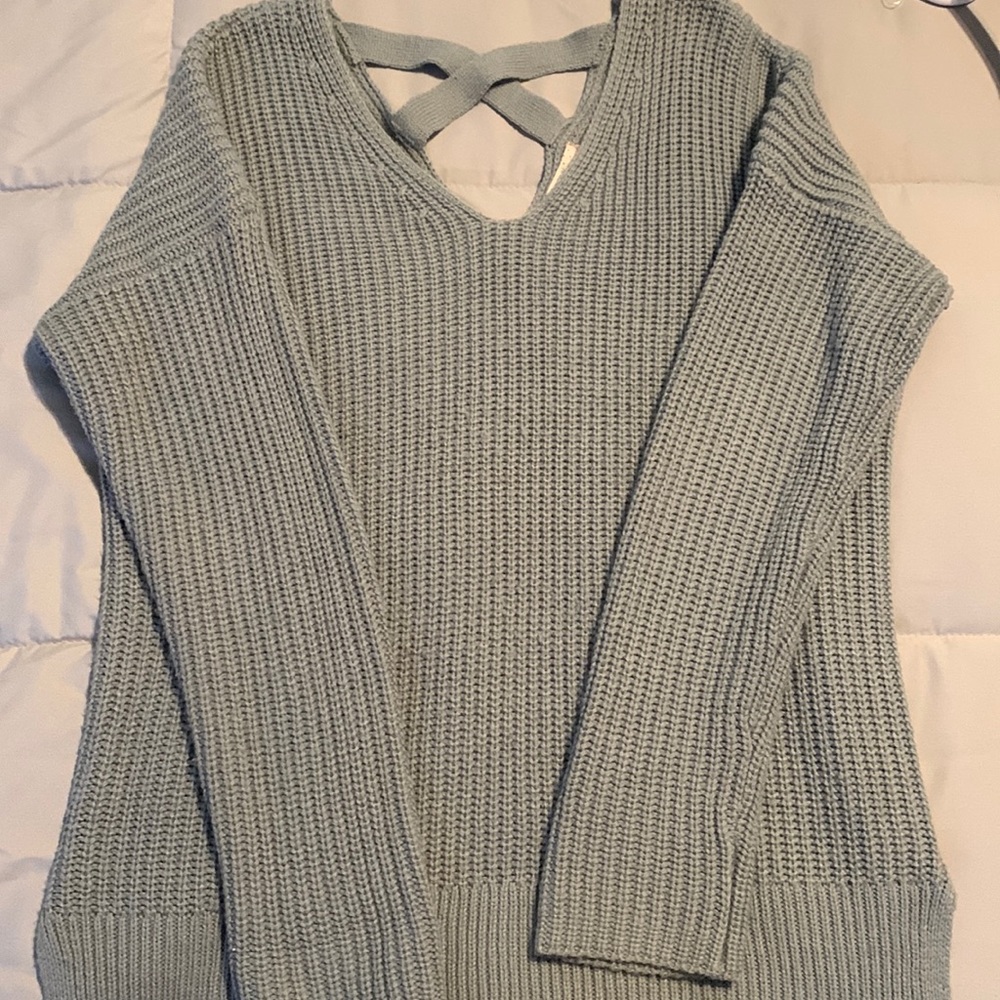 Blue sweater crissed crossed in back